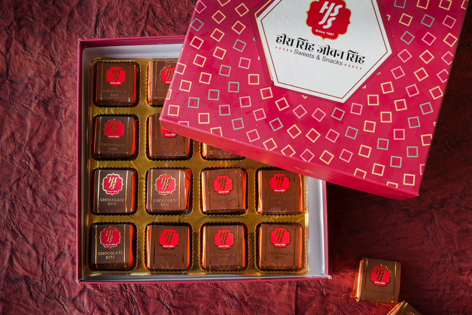 Chocolate bites set in a crimson HSJS presentation box