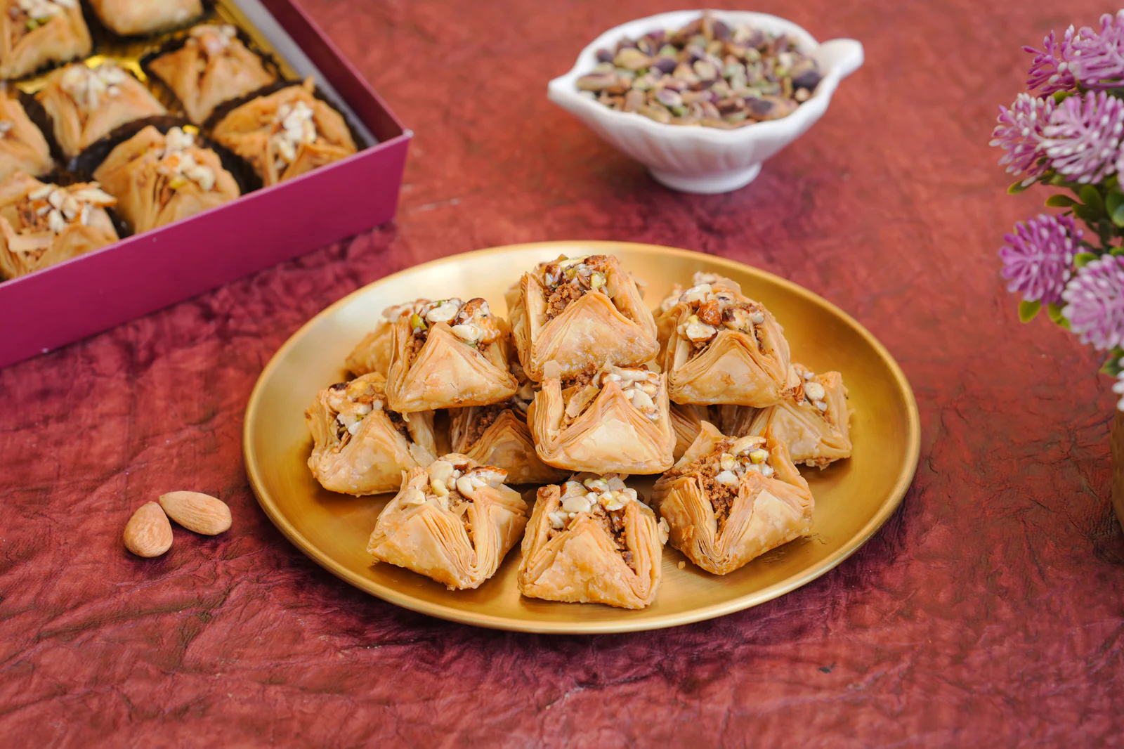 Triangular baklava parcels layered with nuts
